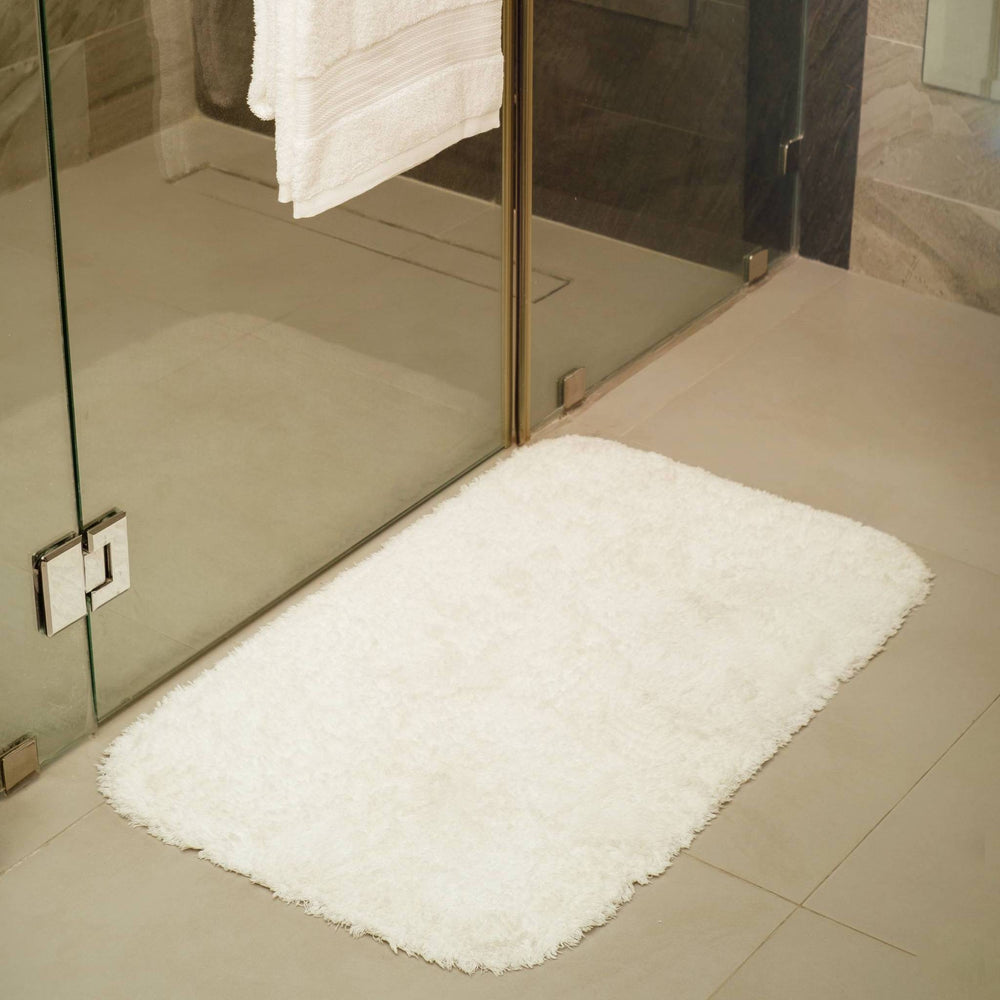 100% cotton bath mat on bathroom floor